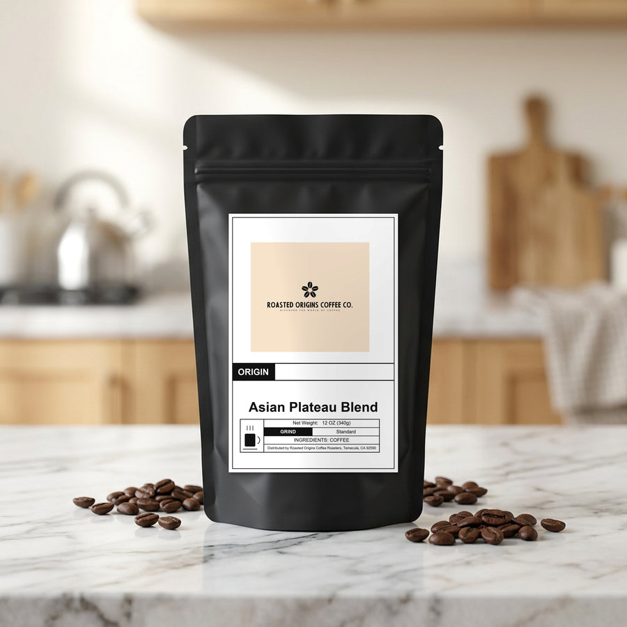 Asian Plateau Blend coffee bag standing on a marble kitchen counter, roasted beans scattered at its base