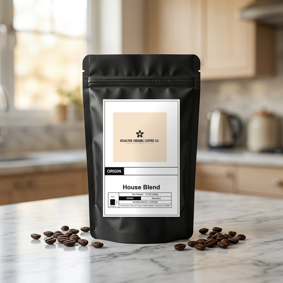 House Blend coffee bag standing on a marble kitchen counter, roasted beans scattered at its base