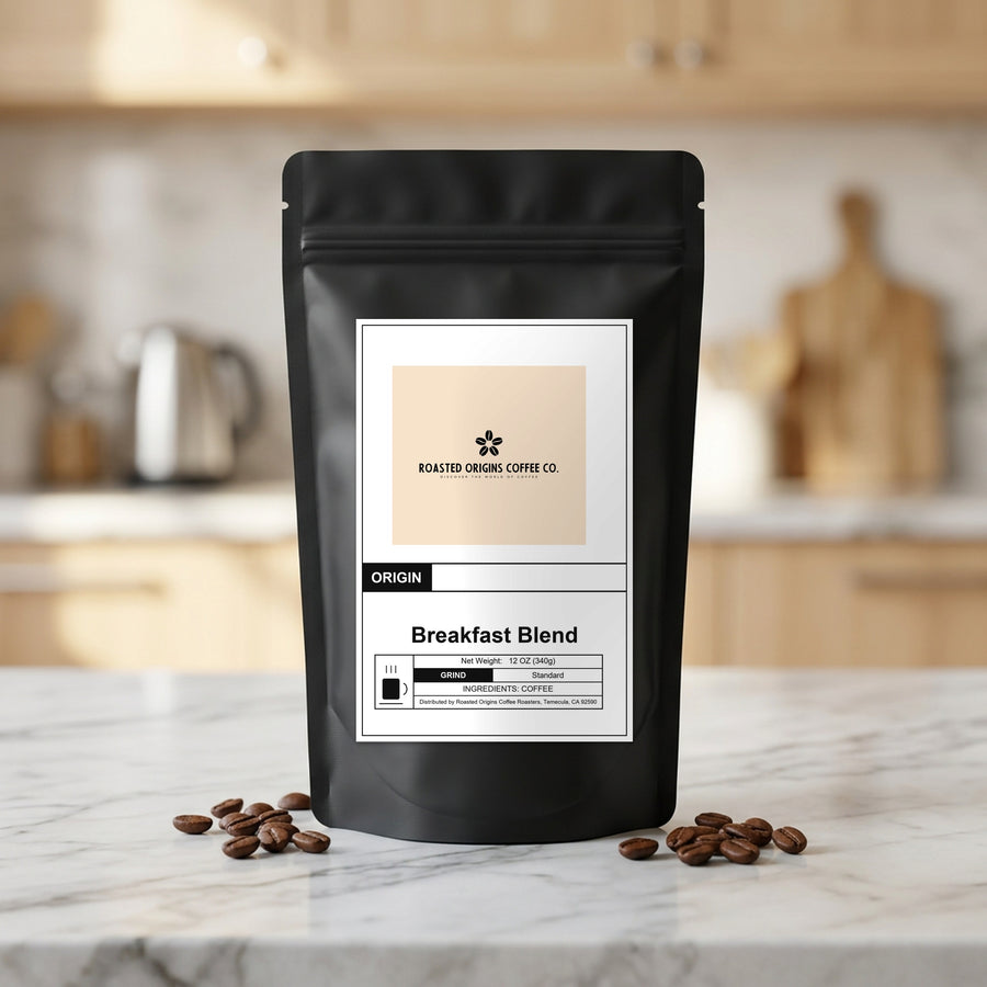 Breakfast Blend coffee bag standing on a marble kitchen counter, roasted beans scattered at its base