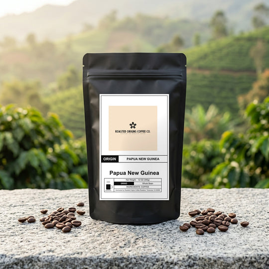 Papua New Guinea coffee bag standing on pale granite outdoors, roasted beans scattered at its base