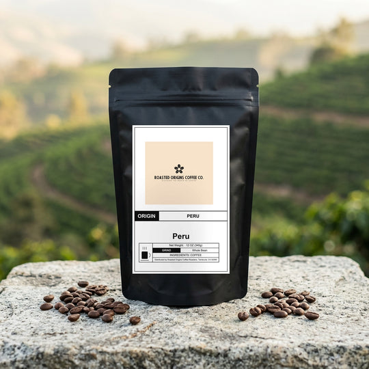 Peru coffee bag standing on pale granite outdoors, roasted beans scattered at its base